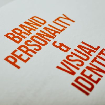 Close-up of 'Brand Personality & Visual Identity' text in red on white paper.